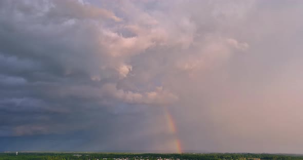 When a Severe Thunderstorm Takes Place a Bright Rainbow Appears in the Sky Against a Beautiful