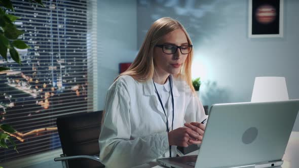 Female Mental Health Professional Providing Online Therapy Session with Patient By Computer