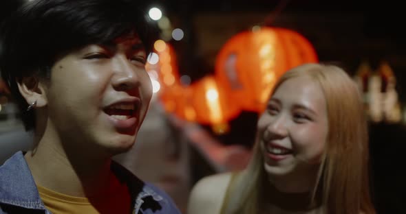 Young Asian couple travel make a video live streaming on social network by smartphone.