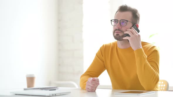 Man Talking on Phone in Office