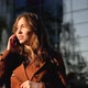 Young woman having phone call outdoors. Girl talking on the phone on the street - VideoHive Item for Sale