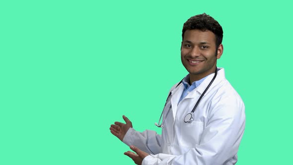Cheerful Male Doctor Showing Copy Space with Hands