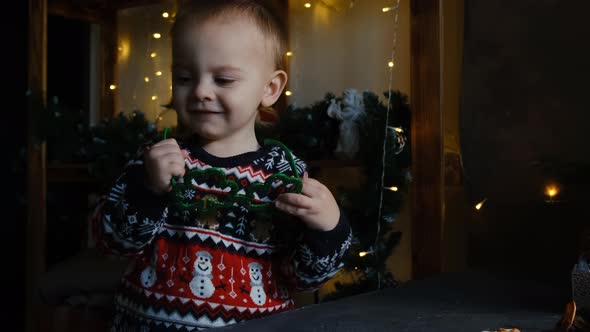 Happy Little Boy in Christmas Sweater with Funny Eyeglasses