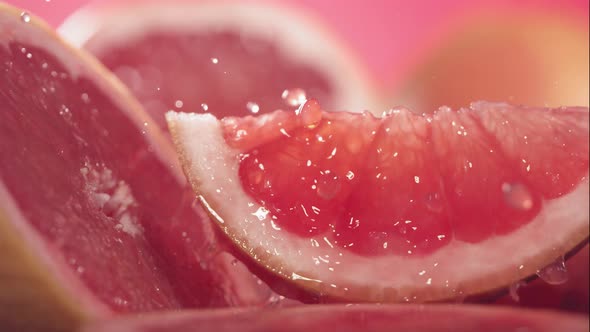 Slow Motion Shot of Grapefruit Juice Splashing Through Grapefruit Slices