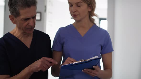 Two caucasian doctors analyzing medical exams. Shot with RED helium camera in 8K.