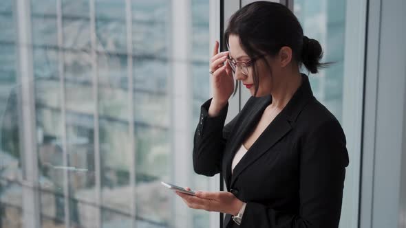 Business Man Uses a Mobile Phone in the Office