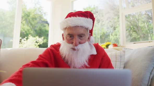 Senior caucasian man at christmas time wearing santa costume