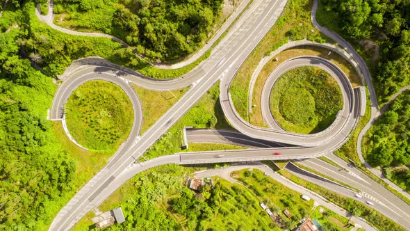 Top down hyperlapse of busy highway in green environment