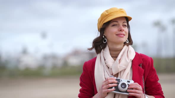 Attractive young girl with a retro camera 