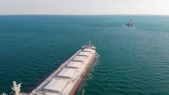 The Bulk Carrier Left the Port and Moves in the Right Direction at High Speed.