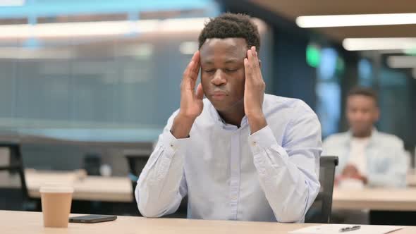 Tense African Businessman Having Headache