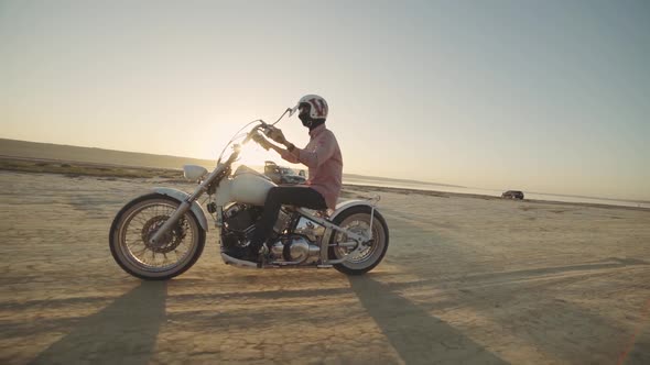 Motorcyclist Driving His Motorbike on the Dirt Road During Sunset Slow Motion