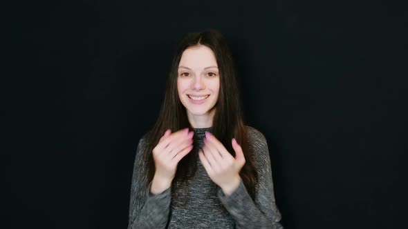 Young Attractive Brunette Woman Sends an Air Kiss To the Camera and Smiling