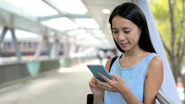 Woman use of smart phone in city 