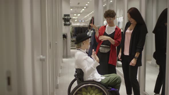 Woman in Wheelchair Trying on Outfit at Clothing Store