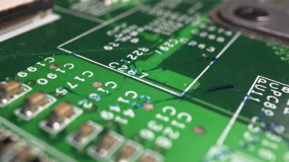 Extreme close-up of green Printed Circuit Board Electronics shot with dolly