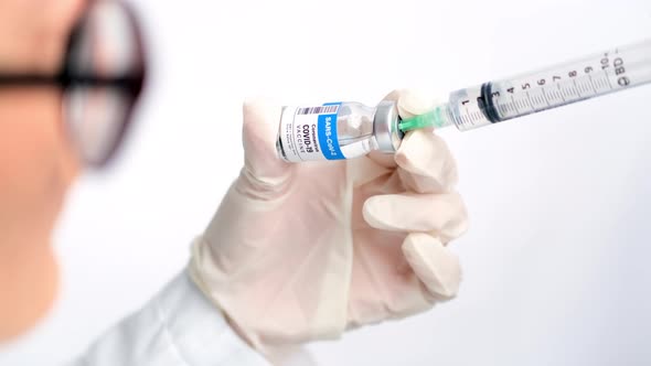 Doctor Extracting the COVID-19 Vaccine from a Vial