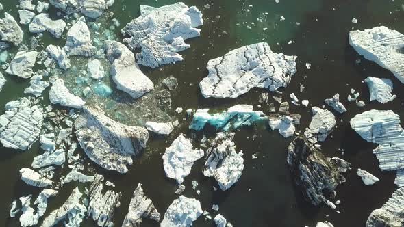 Aerial top down of ice bocks floating in turquoise Jökulsárlón glacial lake near Breiðamerkurjökull 