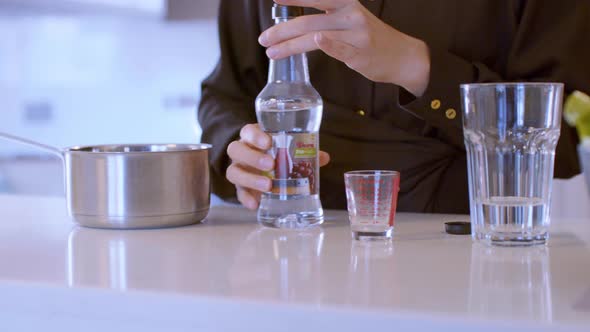 Pouring Vinegar Into A Measuring Glass