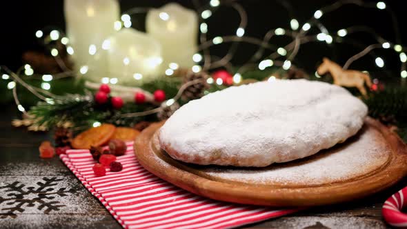 Traditional Christmass Stollen Cake with Marzipan and Dried Fruit on Rustic Background