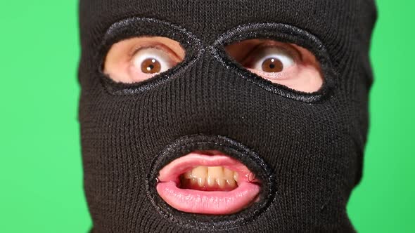 Scary Thief or Robber in Mask Looking at Camera