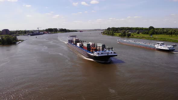 Container Ship Navigating Across The Oude Maas River In Zwijndrecht, Netherlands. aerial