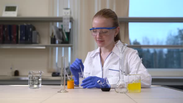 Woman Scientist Mixing Thickening Fluids and Liquid alt