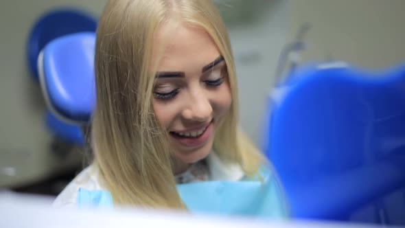 Girl in Dentist's Office Looking in the Mirror