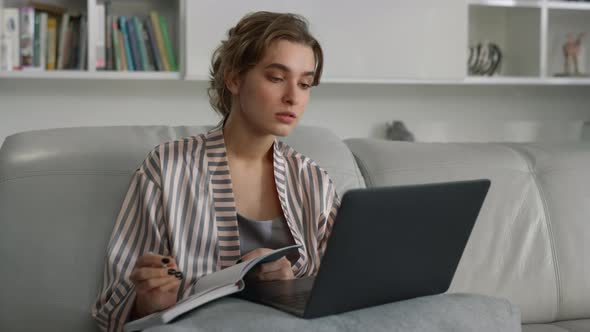 Smiling Girl Studying Home Watching Online University Class in Pajamas Closeup