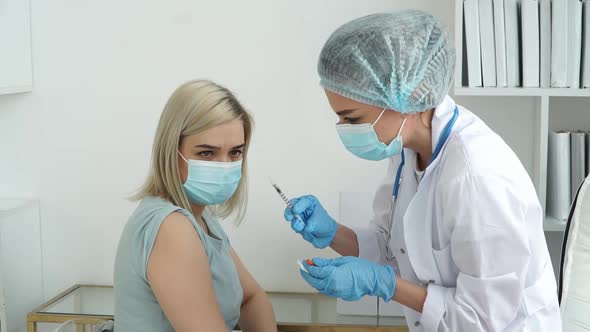 Medical Nurse Vaccinates Patient