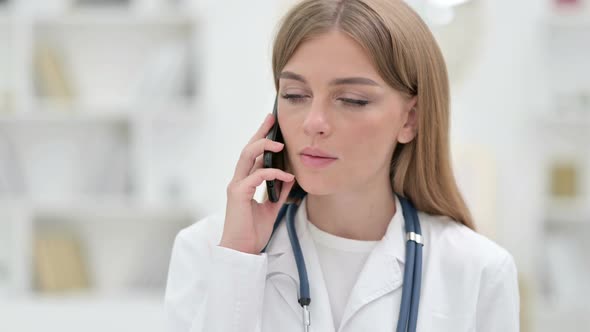 Portrait of Professional Young Doctor Talking on Smartphone 