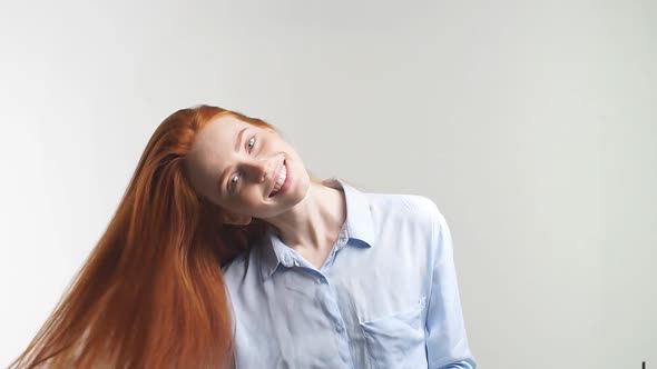 Happy Attractive Girl with Curly Red Hair Smiling Looking at Camera. Slow Motion.