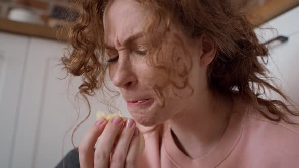 Young caucasian woman eating greedily some snacks.  Shot with RED helium camera in 8K.