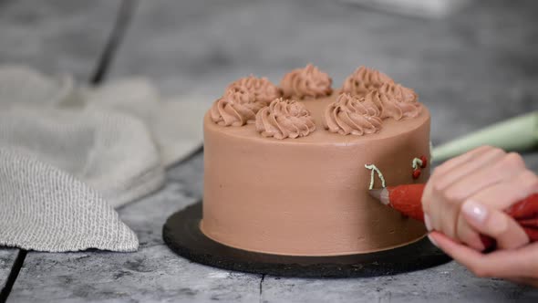 Chef Decorating Chocolate Cake with Cream