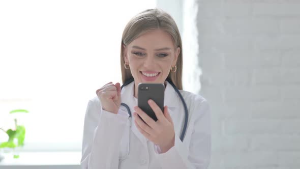 Portrait of Lady Doctor Celebrating on Smartphone