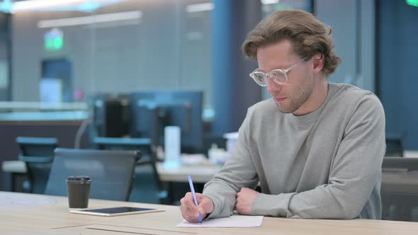 Young Businessman Trying to Write on Paper Failure