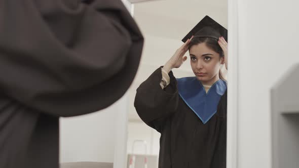 Female Graduate Dressing for Graduation Ceremony