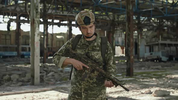 Portrait of Patriot Soldier with Gun in Hands on Factory