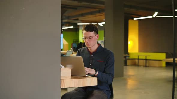 Sexy Attractive Male Wearing Glasses Typing Something on Laptop