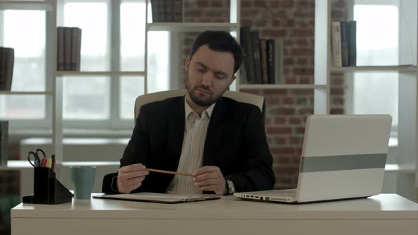 Businessman Sitting Thinking in an Office and Have a New Idea in His Mind