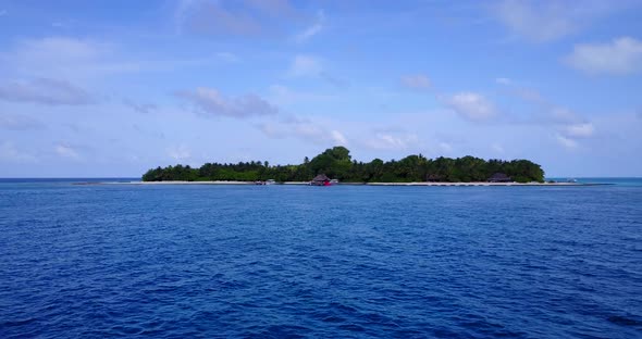 Tropical birds eye copy space shot of a sandy white paradise beach and aqua blue ocean background in