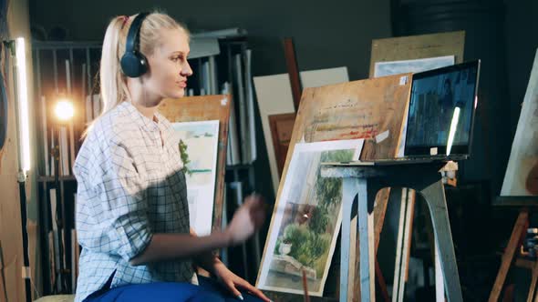 Blond Woman is Having a Remote Art Lesson