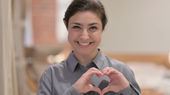 Portrait of Young Indian Woman Making Heart Shape with Hands