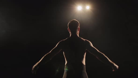 A Man is Dressing in Tights is Standing on the Stage