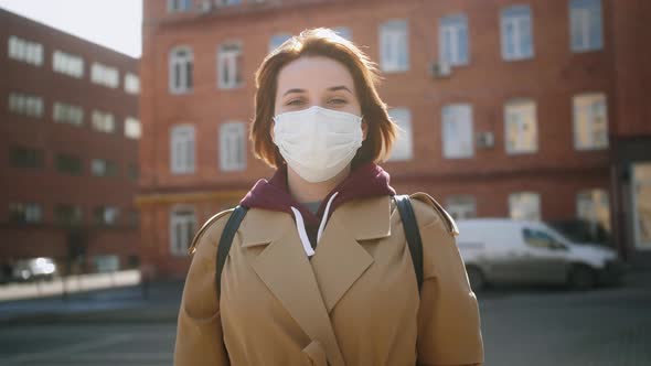 Portrait of Young Woman Wearing Protective Mask on Street
