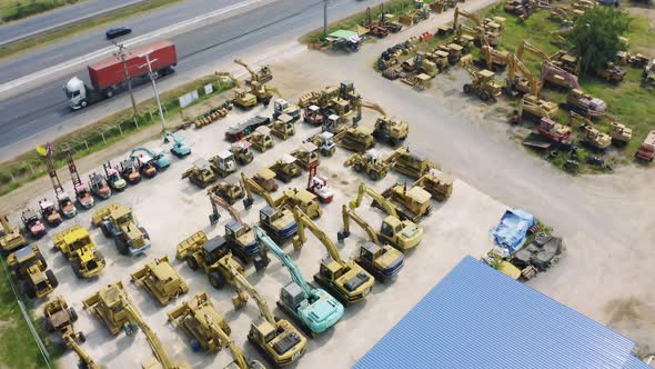 Aerial top view of new truck tractor cars parking for sale stock lot row, dealer inventory import