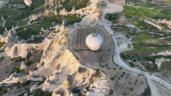 4K Aerial view of Goreme. Colorful hot air balloons fly over the valleys.