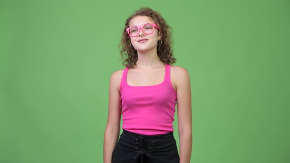 Young Happy Beautiful Nerd Woman Smiling While Waving Hand