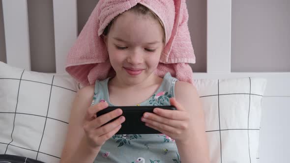 Little Girl with a Smartphone in Her Hands