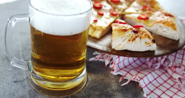 Delicious pizza with a glass of beer